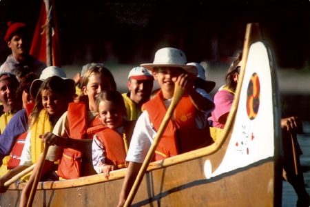 Kids in a voyageur canoe.