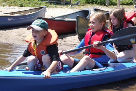 Kids out paddling in a sit-on-top kayak
