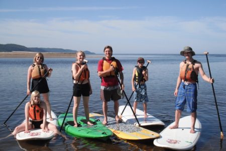 Family out on the stand up paddling (sup) boards at Naturally Superior Adventures