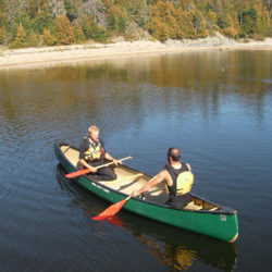 Two canoeists facing each other in a canoe lesson at Naturally Superior Adventures