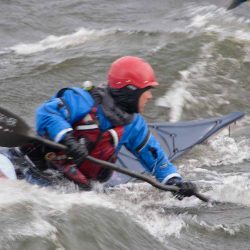 Kayak surfing in rough water at naturally superior adventures
