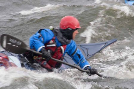 Kayak surfing in rough water at naturally superior adventures