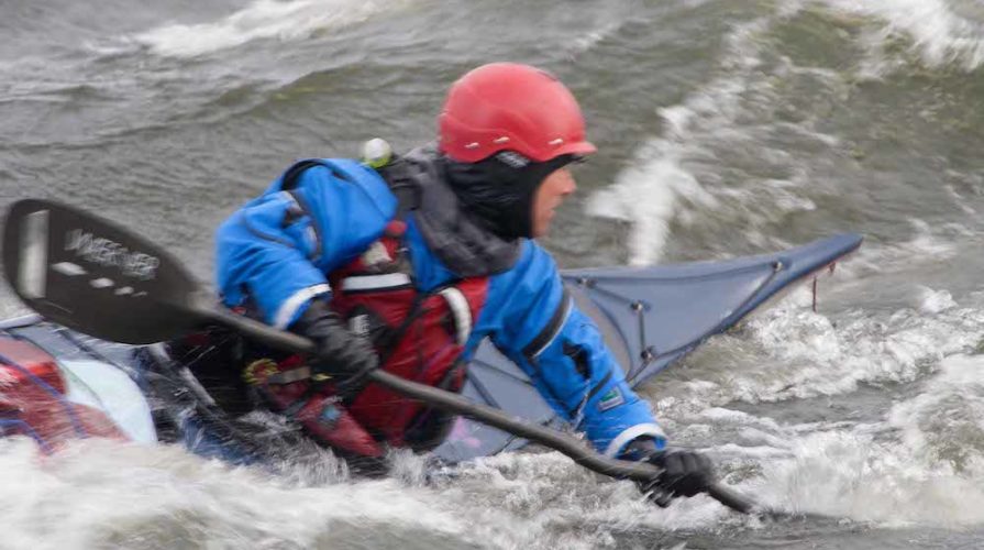 Kayak surfing in rough water at naturally superior adventures