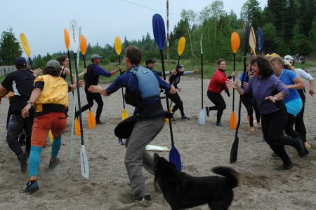sea kayak students playing a warm-up game on the beach at naturally superior adventure