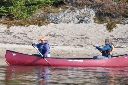 A family out on a self-guided eco tour in a canoe at naturally Superior Adventures